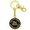 Llavero dorado de El Señor de los Anillos con medallón negro