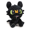 Peluche negro de Desdentao con ojos verdes y mariposa naranja