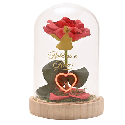 Flor roja de Bella Disney bajo campana con corazón iluminado