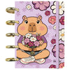 Cuaderno A6 Flower Capibara con portada floral lavanda y discos dorados