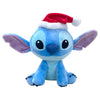Peluche Stitch Disney sentado con gorro de Santa rojo